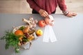 Closeup on housewife putting money into piggy bank Royalty Free Stock Photo