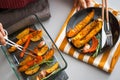 Closeup on young housewife serving baked pumpkin