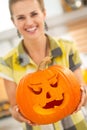 Closeup on housewife showing big pumpkin Jack-O-Lantern Royalty Free Stock Photo