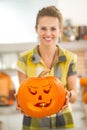 Closeup on housewife showing pumpkin Jack-O-Lantern with candle Royalty Free Stock Photo