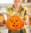 Closeup on housewife showing pumpkin Jack-O-Lantern with candle Royalty Free Stock Photo