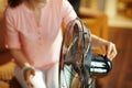 Closeup on housewife swtitching on metallic floor standing fan Royalty Free Stock Photo