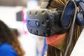 Closeup of a HTC Vive virtual reality headset worn by a girl