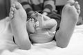 Closeup of huge feet of father and little newborn baby