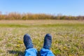 Closeup human feet lie on a grass