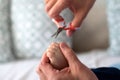 Closeup of human hand holding scissors to cut toddler toe nails Royalty Free Stock Photo