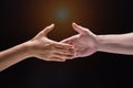 Closeup human hand ,between mand and woman.they are reaching to touch together,the sign and symbol of friendship Royalty Free Stock Photo