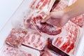 Closeup of human hand picking a pack of red meat Royalty Free Stock Photo