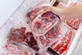 Closeup of human hand picking a pile of red meat Royalty Free Stock Photo