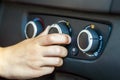 Closeup of a human hand rotating car temperature control, shallow depth of field shot Royalty Free Stock Photo