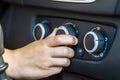 Closeup of a human hand rotating car temperature control, shallow depth of field shot Royalty Free Stock Photo