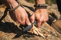 Human hands carving a wooden stick with knife in nature Royalty Free Stock Photo