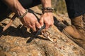 Human hands carving a wooden stick with knife in nature Royalty Free Stock Photo