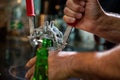 Closeup of human hands holding bottle capper