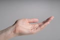 Closeup of human open hand palm on grey background