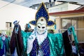 Closeup human in original vivid costume poses for photo at dominican carnival