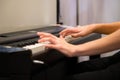 Closeup humans hands playing electronic piano. Favourite classical music. Music classes, learning how to play musical instrument