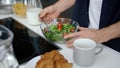 Closeup hungry man eating fresh salad at home kitchen in slow motion. Royalty Free Stock Photo