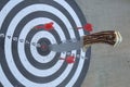 Closeup of a hunting knife on the bullseye of a dartboard under the lights Royalty Free Stock Photo