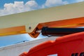 Closeup hydraulic of boom lift. Orange articulated boom lift. Maintenance and repair hydraulic boom lift service. Aerial platform