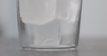 Closeup ice cubes in tumbler glass on concrete countertop Royalty Free Stock Photo