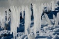 Closeup of icicles covering security fence on a sunny winter Royalty Free Stock Photo