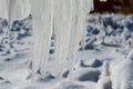 Closeup of icicles covering security fence on a sunny winter Royalty Free Stock Photo