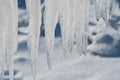 Closeup of icicles covering security fence on a sunny winter Royalty Free Stock Photo
