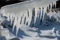 Closeup of icicles covering security fence on a sunny winter Royalty Free Stock Photo