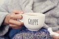 Ill man and mug with word grippe, flu in french Royalty Free Stock Photo