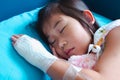 Illness asian child admitted in hospital with saline intravenous on hand
