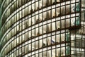 Closeup of an illuminated office building exterior full of glazed windows at night. Window pattern or lit glazed facade Royalty Free Stock Photo