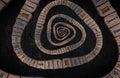 Closeup illustration of a wooden infinity time spiral on black background Royalty Free Stock Photo