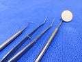 Closeup Image Of Basic Dental Instruments Set Arranged On Blue Wrapping Sheet