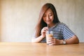 A beautiful asian woman drinking iced coffee with stainless steel straw Royalty Free Stock Photo