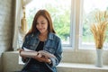 A beautiful asian woman sitting and reading book at home Royalty Free Stock Photo