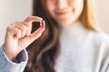 A beautiful woman holding and looking at a red gummy bear Royalty Free Stock Photo