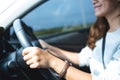 A beautiful young asian woman holding steering wheel while driving a car Royalty Free Stock Photo