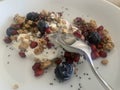 Closeup image of a bowl of organic yoghurt, granola, blueberries, pomegranate arils, chia seeds and honey Royalty Free Stock Photo