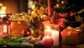 Closeup image of burning candles in traditional wreath against Christmas tree and fireplace Royalty Free Stock Photo