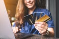 A business woman holding credit cards while using laptop computer Royalty Free Stock Photo