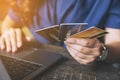 A business woman holding credit cards while using laptop computer Royalty Free Stock Photo