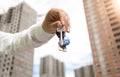 Closeup image of businessman hand holding keys from new apartment. Concept of real estate investment Royalty Free Stock Photo