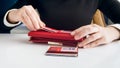 Closeup photo of businesswoman inserting credit card in leather purse Royalty Free Stock Photo