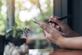 A businesswoman`s hand working and holding a white blank notebook with screwed up papers on table Royalty Free Stock Photo