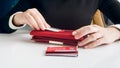 Closeup photo of businesswoman sorting credit cards and putting them in wallet