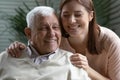 Closeup image candid grown up daughter hugs elderly father Royalty Free Stock Photo