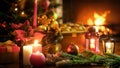 Closeup image of candles and lanterns against Christmas tree and burning fireplace Royalty Free Stock Photo