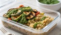 A closeup image capturing a layered mealprep container where earthy quinoa forms the base topped with roasted zucchini Royalty Free Stock Photo