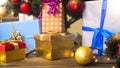 Closeup image of colorful baubles and gift boxes under Christmas tree at living room Royalty Free Stock Photo